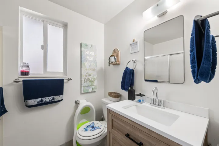 Full bath with a shower stall and vanity