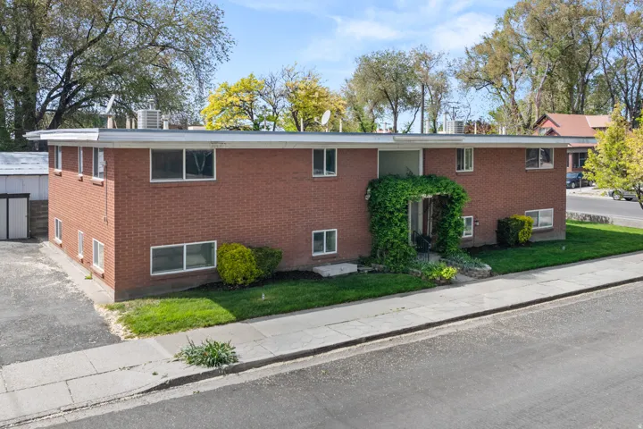 View of front of property featuring brick siding and front yard.