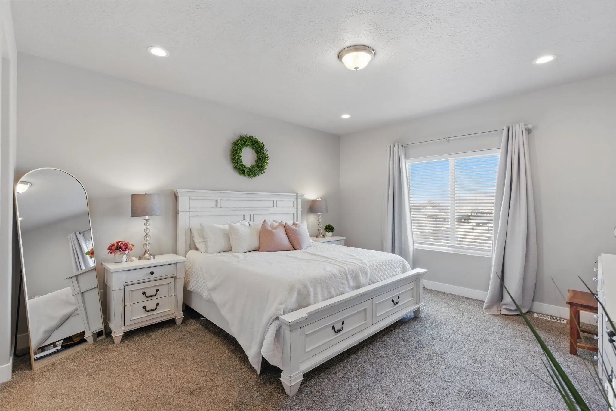 Bedroom with light carpet, recessed lighting, and a textured ceiling