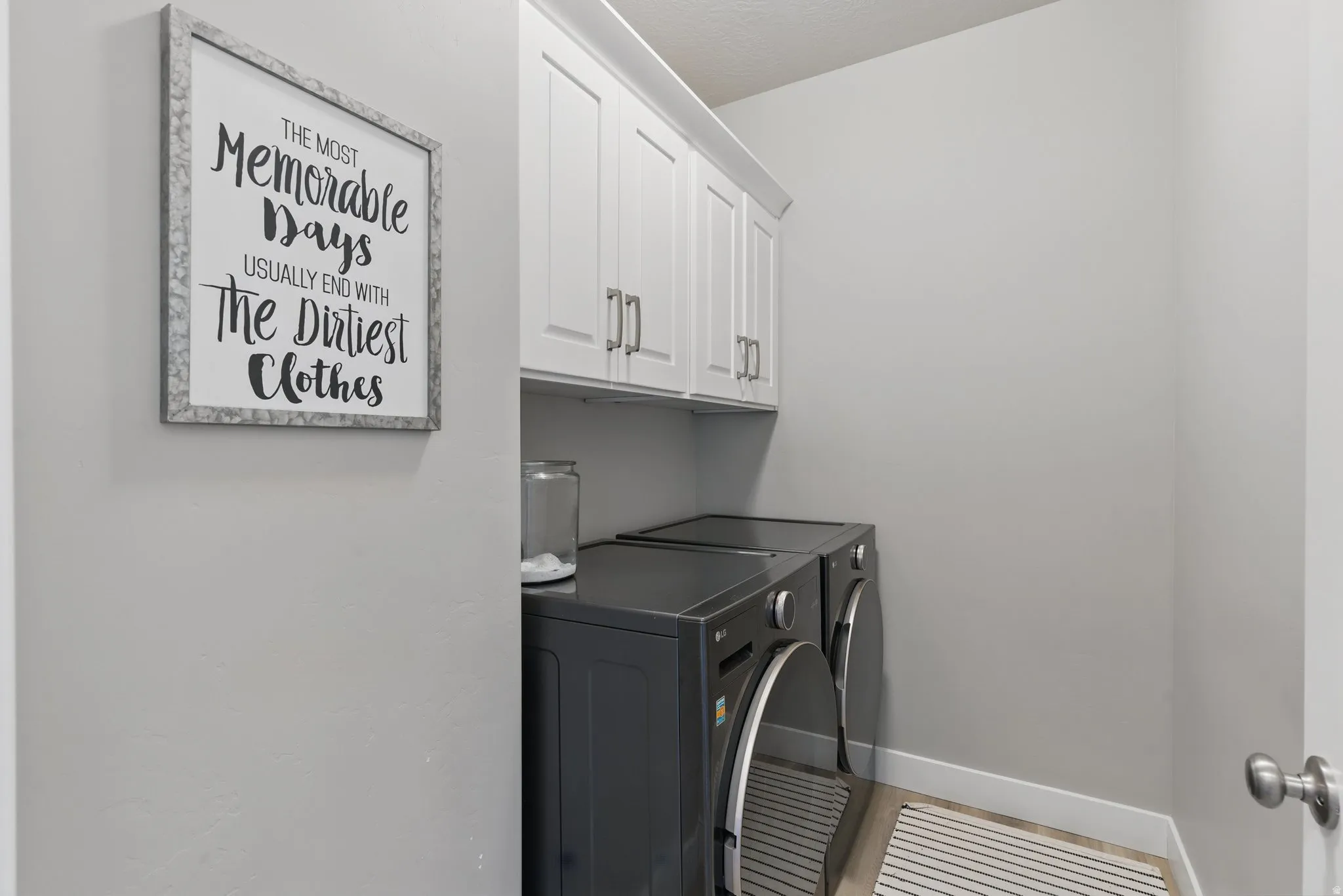 Laundry area with cabinet space and independent washer and dryer