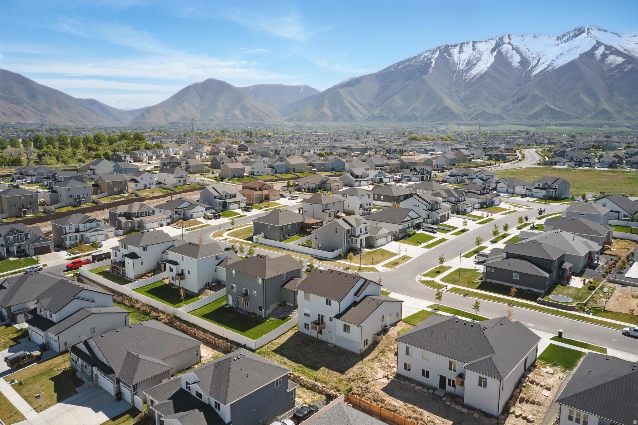 Aerial perspective of suburban area featuring a mountain backdrop