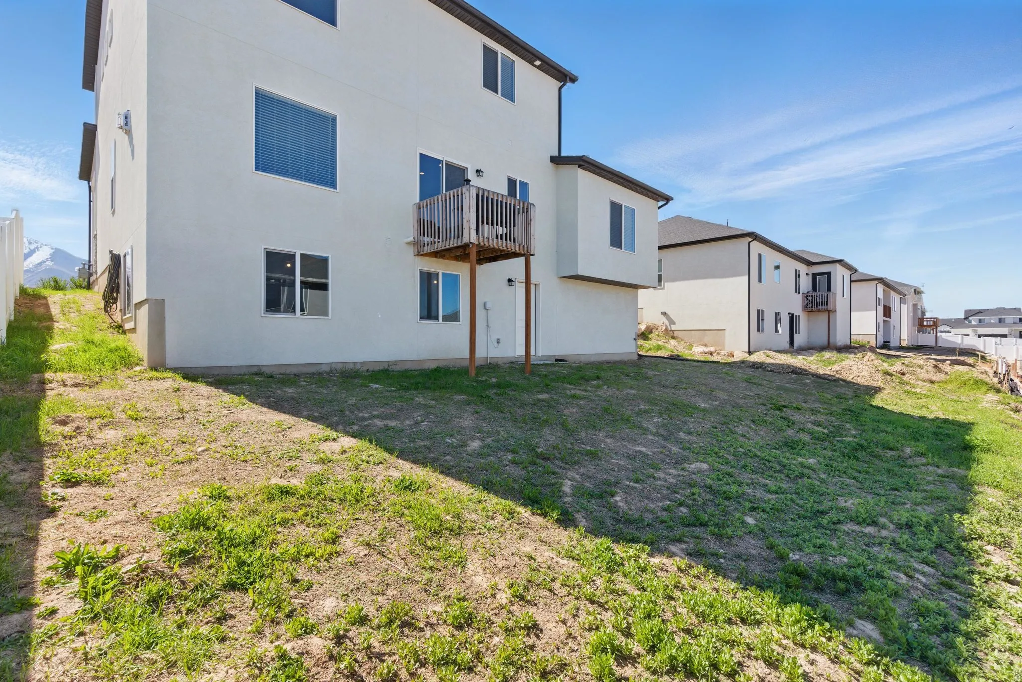 Rear view of property with stucco siding and a yard