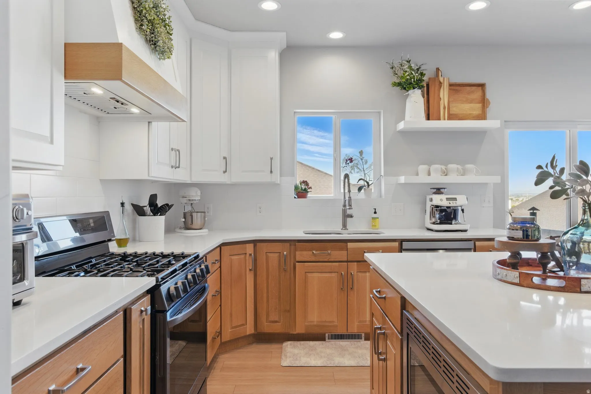 Kitchen with stainless steel appliances, open shelves, recessed lighting, tasteful backsplash, and white cabinets