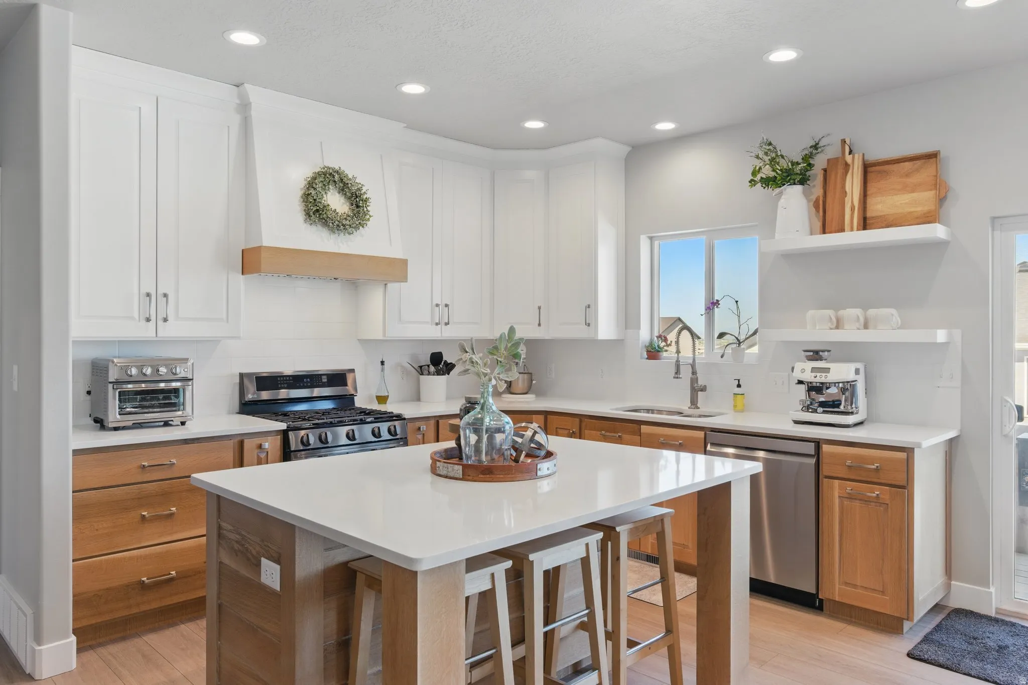 Kitchen with open shelves, decorative backsplash, stainless steel appliances, recessed lighting, and dual tone cabinetry