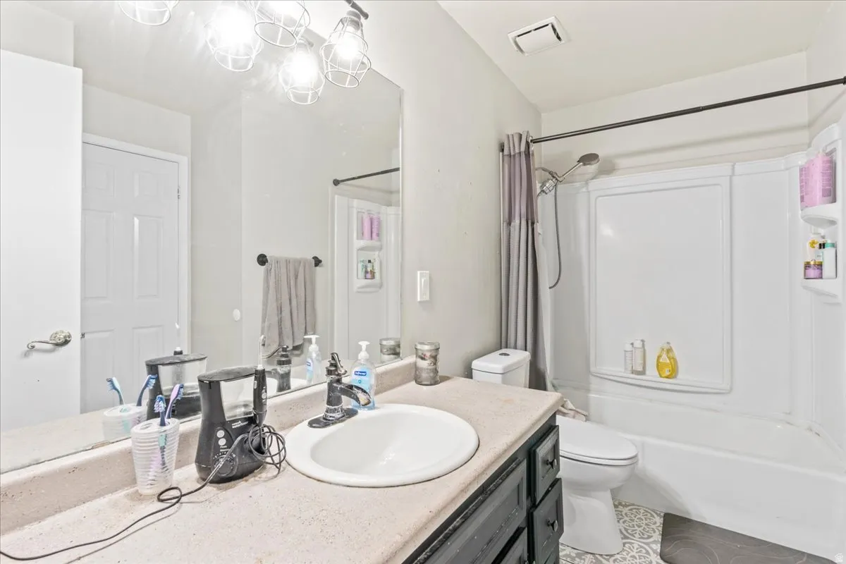 Bathroom featuring vanity and shower / bath combo