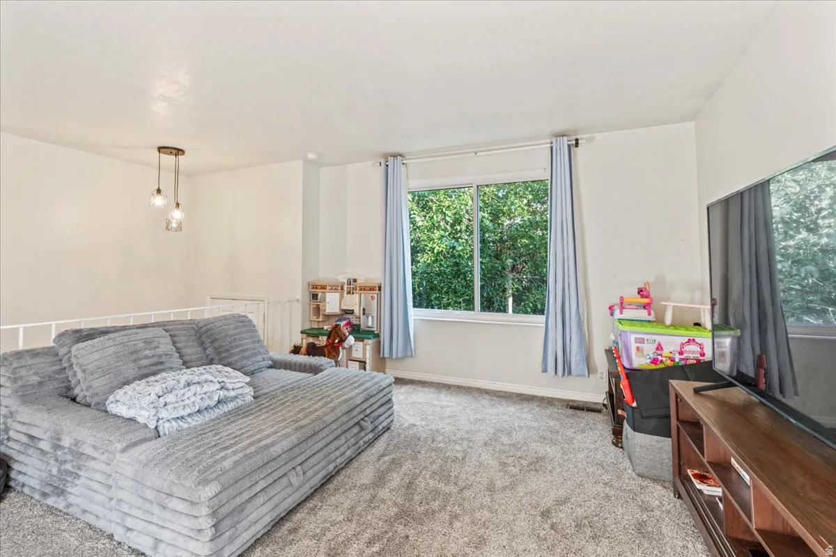 Living area with light carpet and baseboards