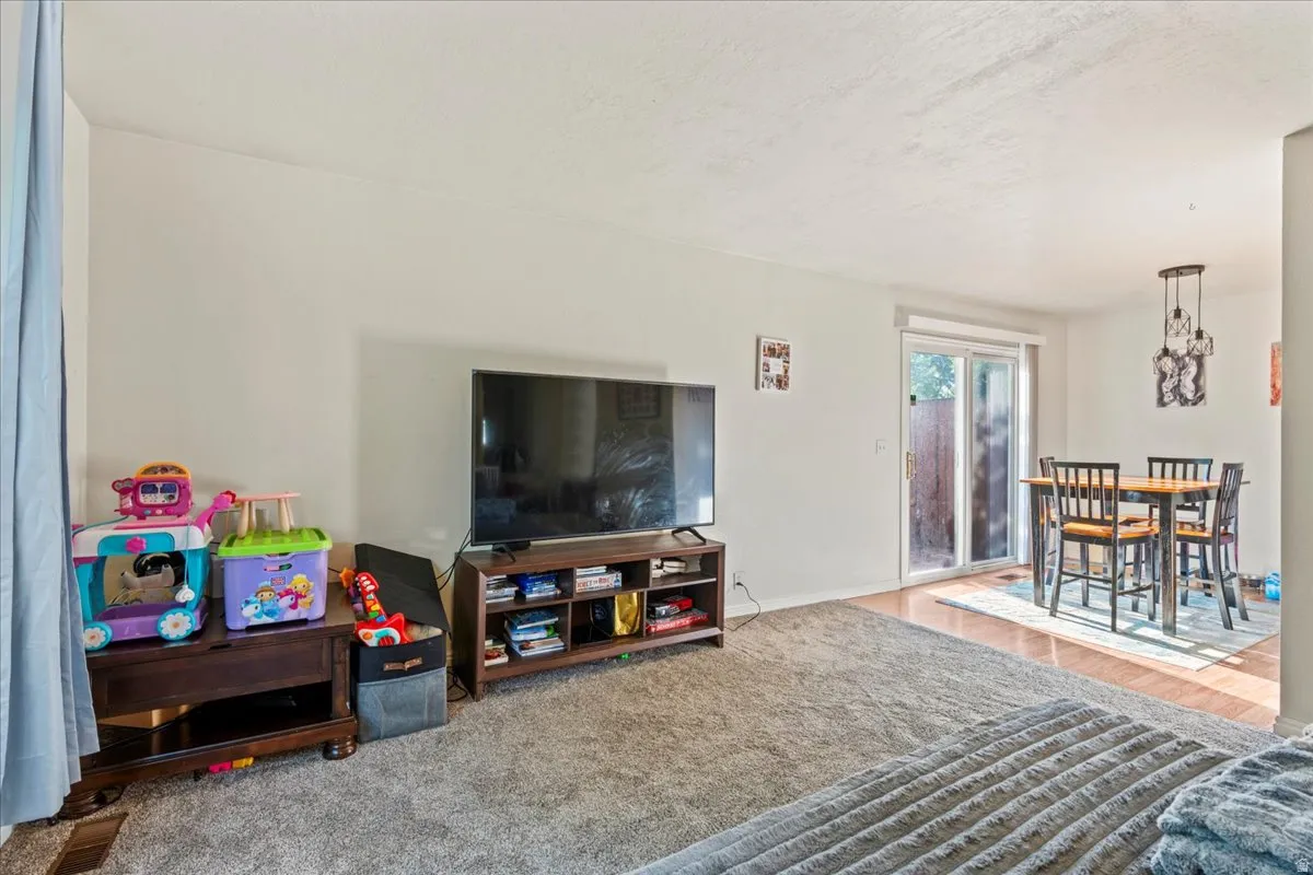 Living area with a textured ceiling and wood finished floors