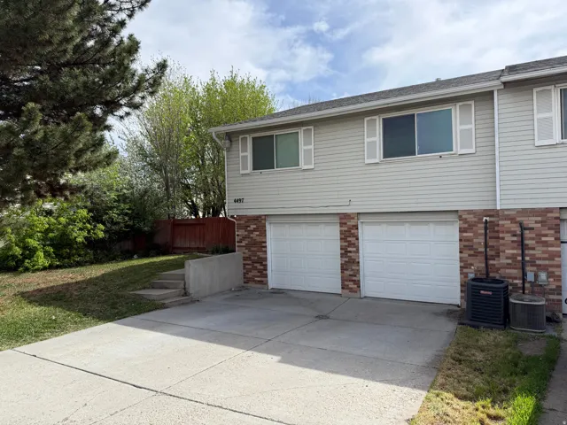 View of home's exterior featuring brick siding, concrete driveway, and a garage