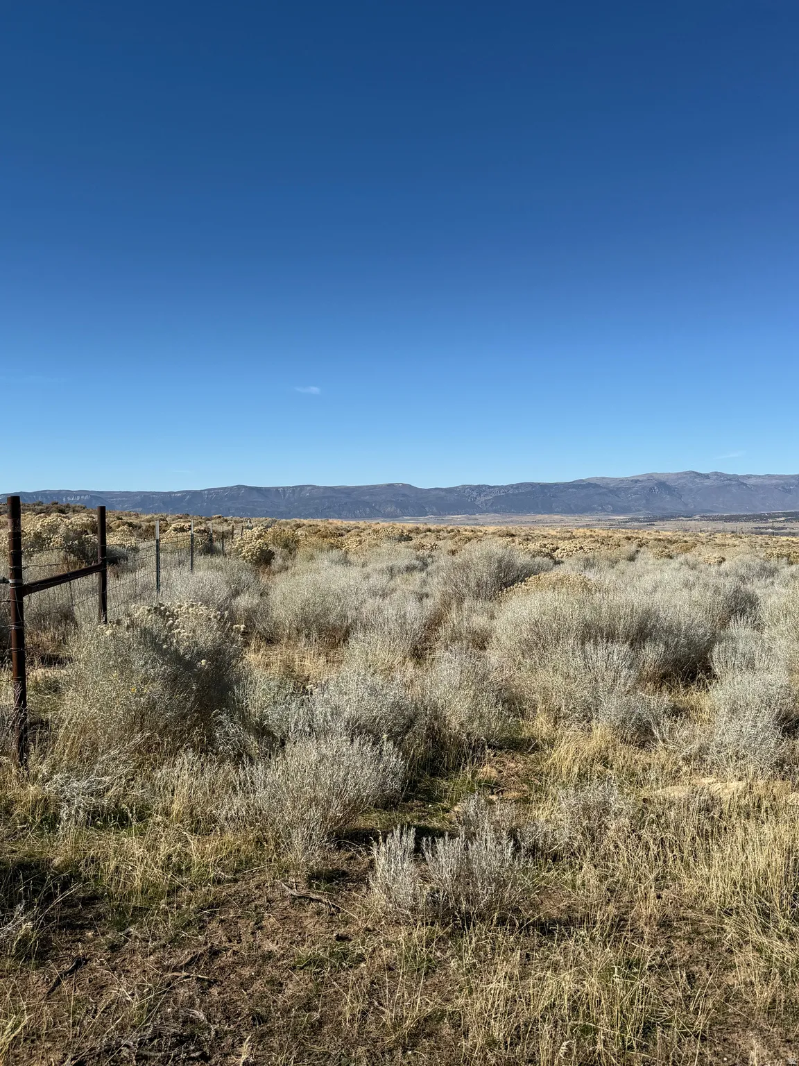 View of mountain backdrop with rural landscape