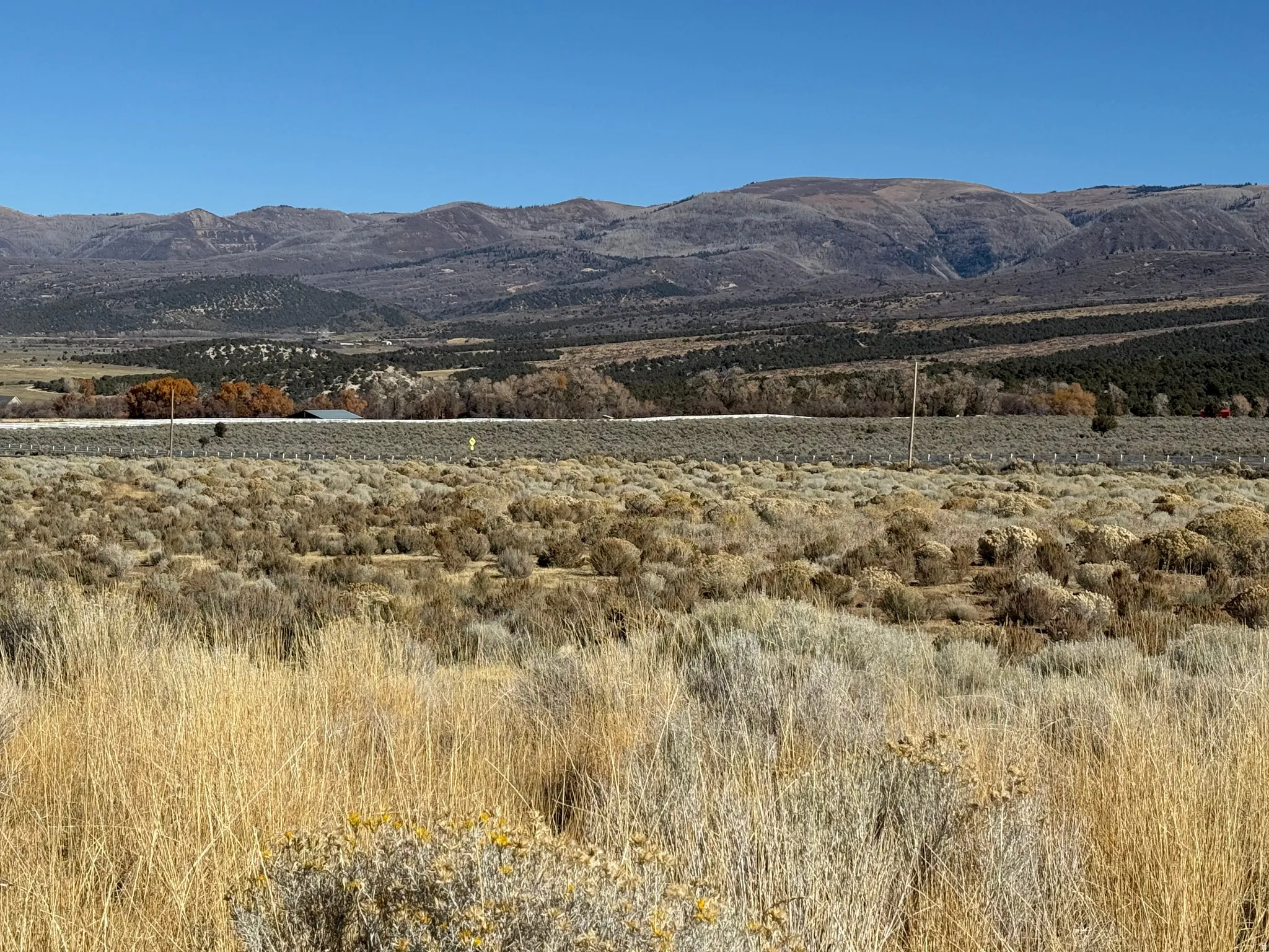 View of mountain background featuring rural landscape