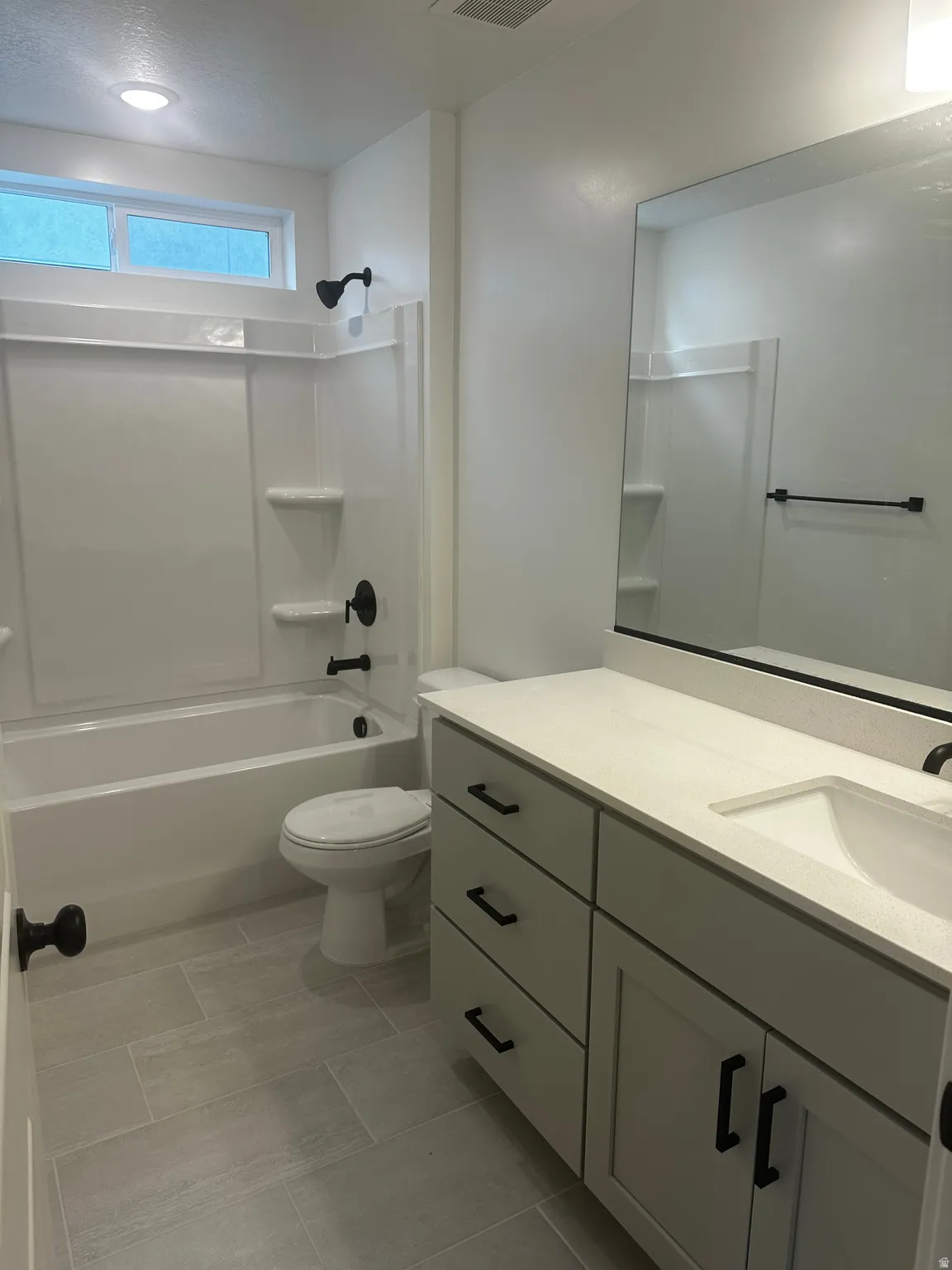 Bathroom featuring vanity and tub / shower combination