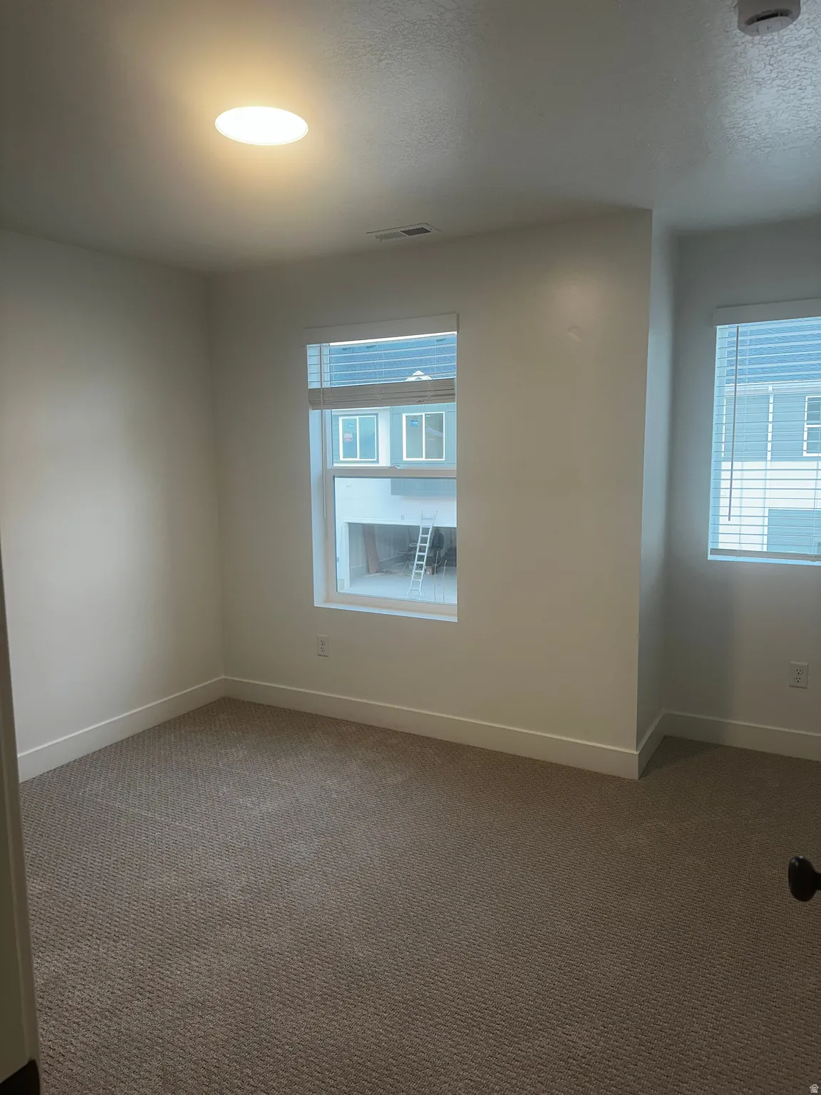 Empty room featuring carpet and healthy amount of natural light