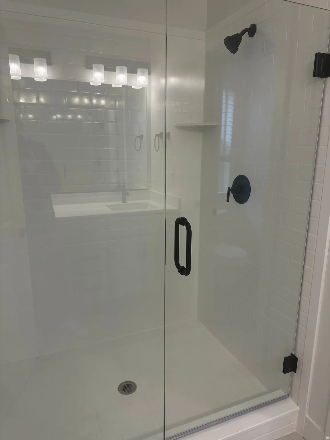 Full bath featuring a stall shower and a sink