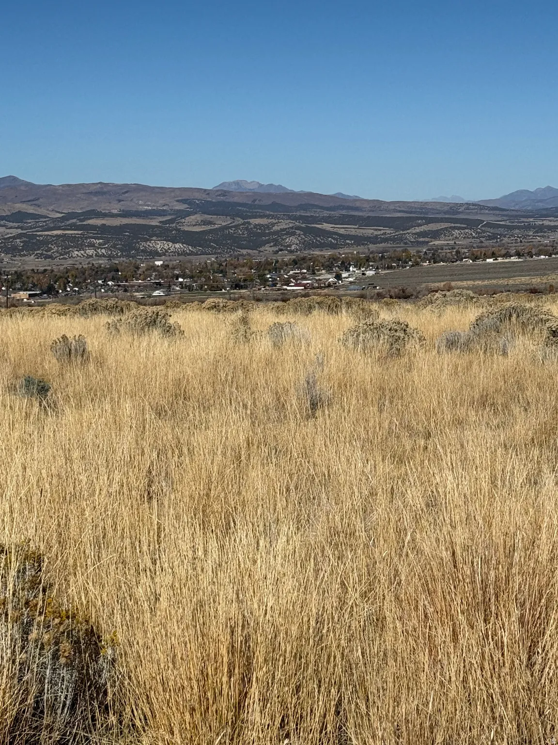 View of mountain backdrop with rural landscape