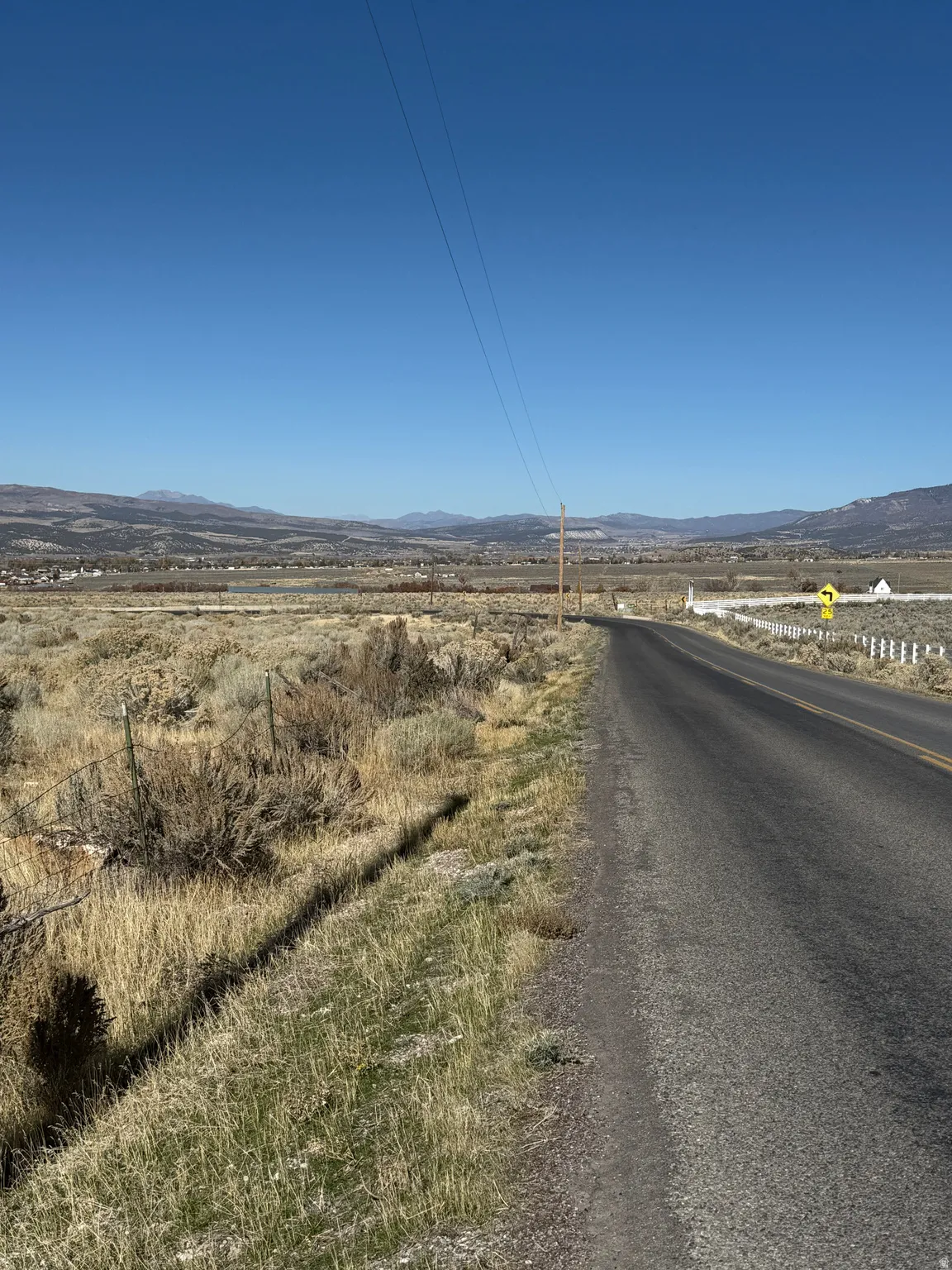 View of asphalt road with a mountain view and a view of countryside