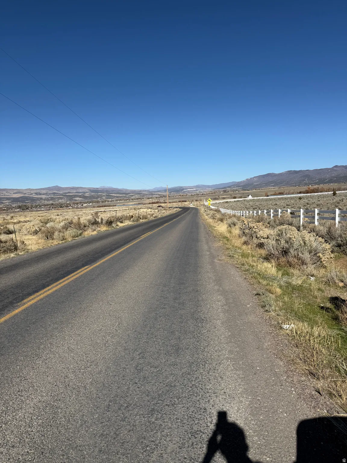 View of asphalt road with a mountain view and a view of countryside