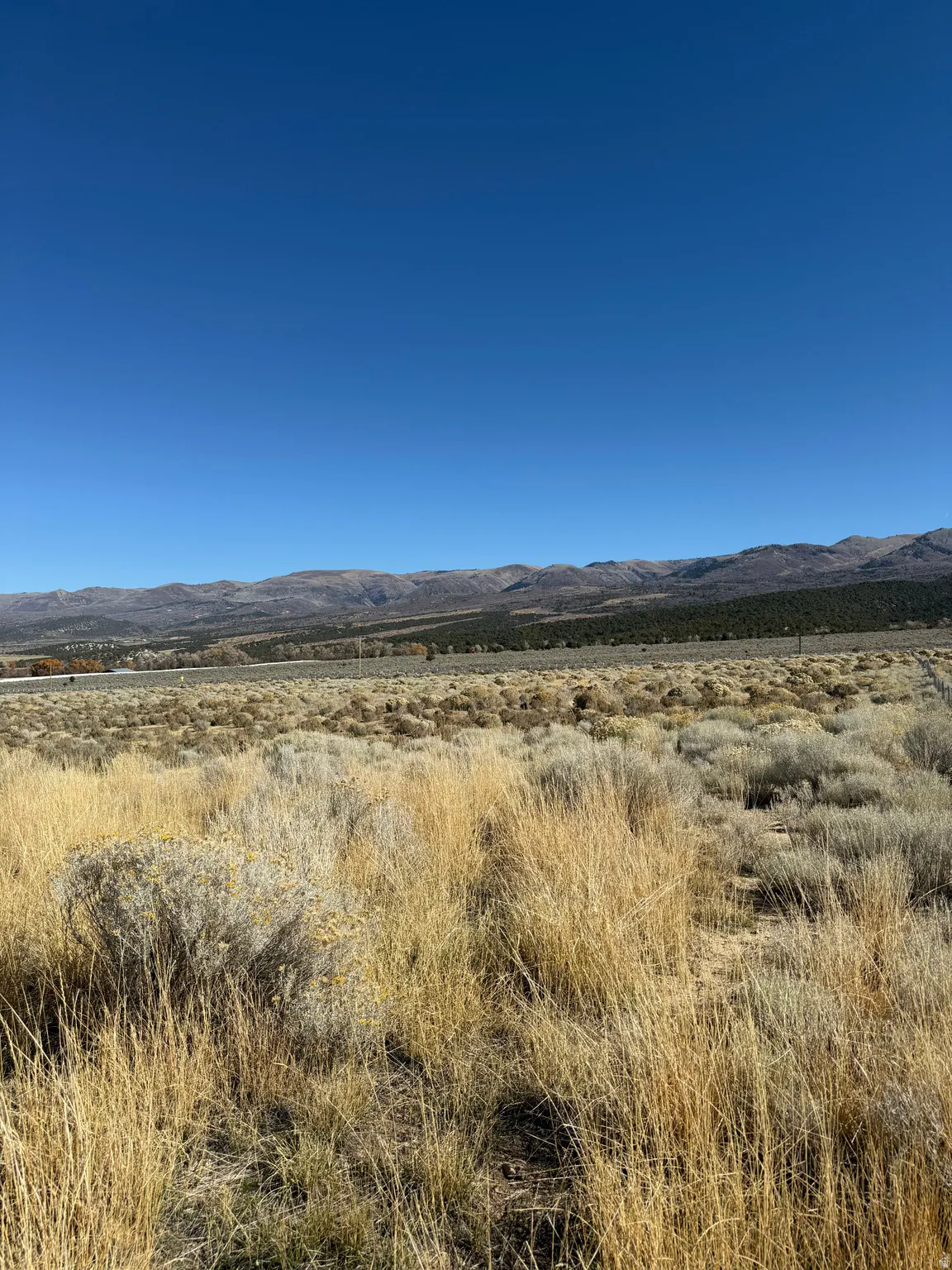 View of mountain background featuring rural landscape