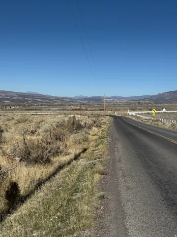 View of asphalt road with a mountain view and a view of countryside