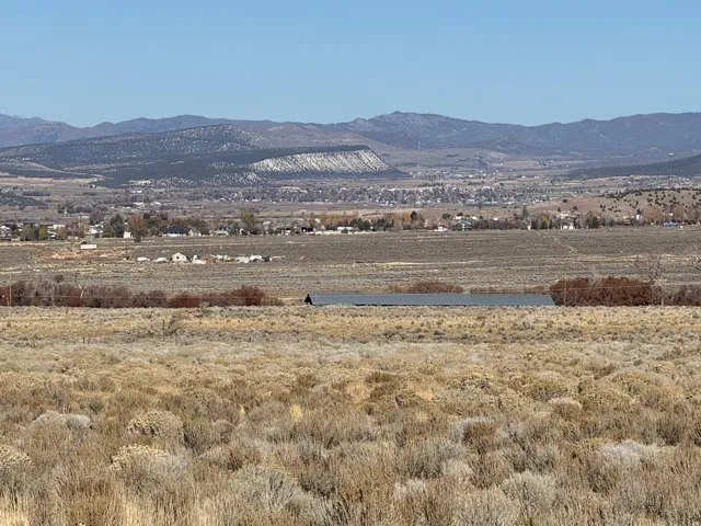 View of mountain backdrop with rural landscape