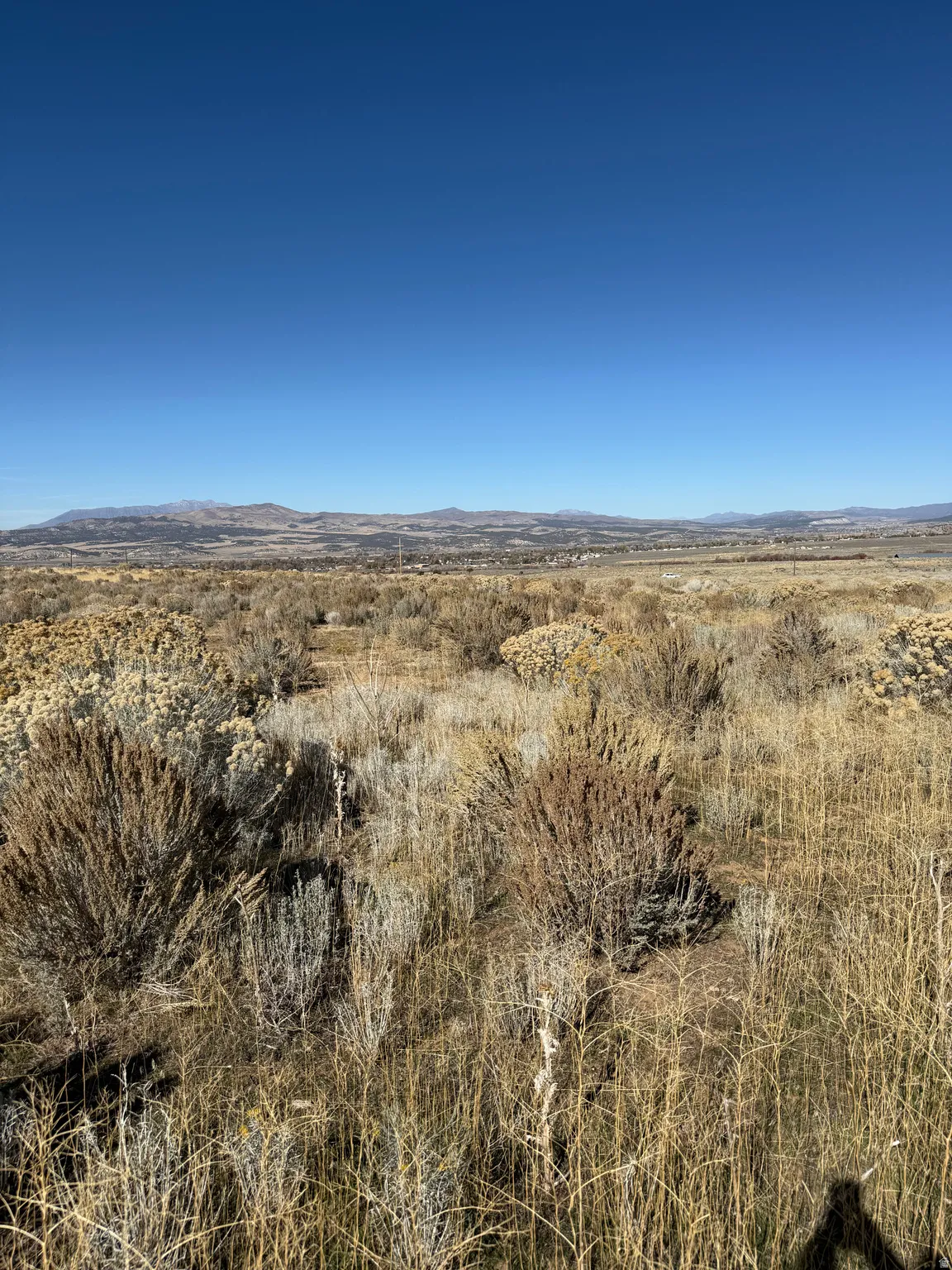View of mountain backdrop with rural landscape