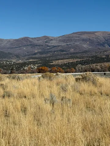 View of mountain backdrop featuring rural landscape