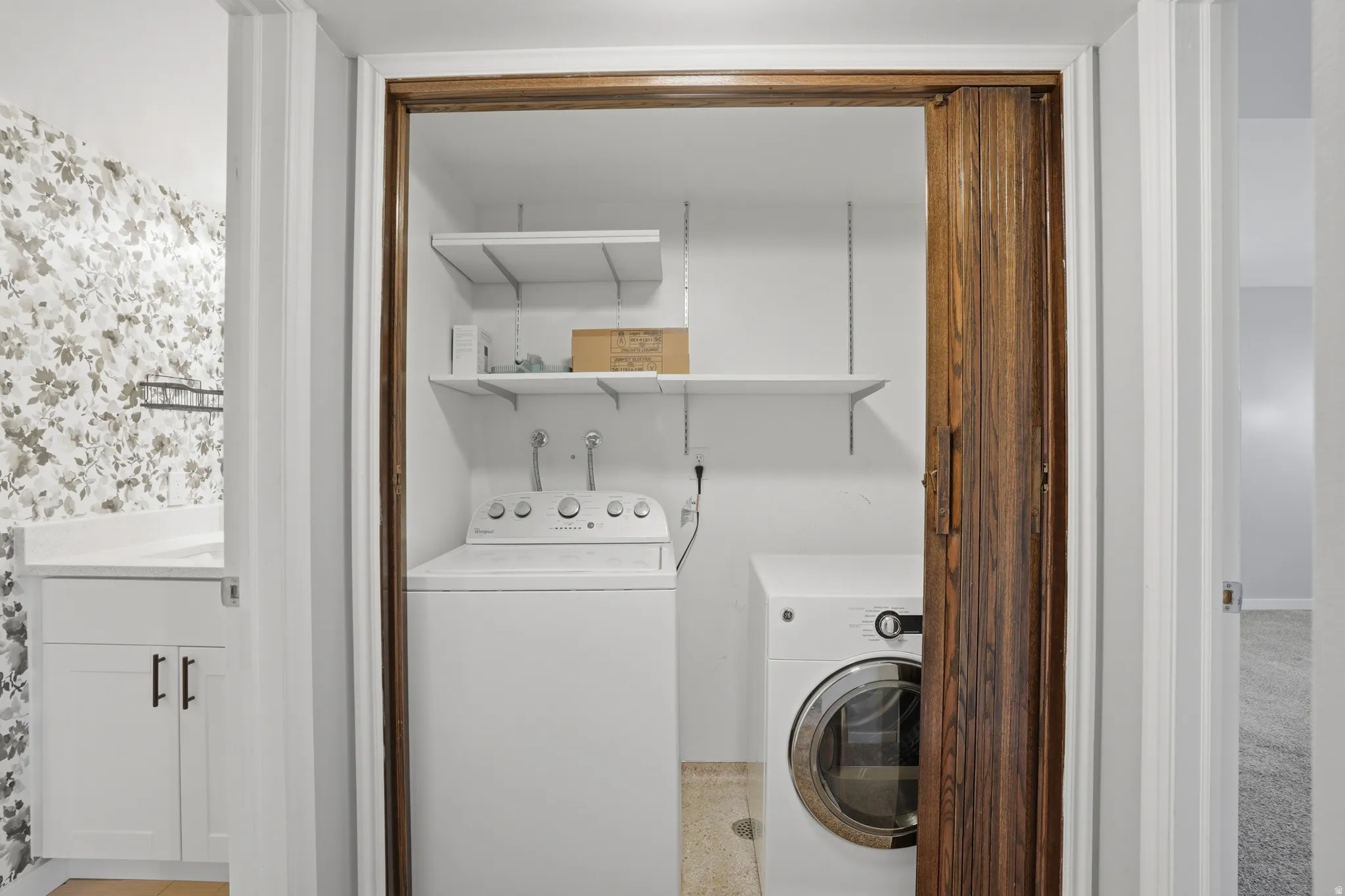 Laundry area featuring washer and clothes dryer, included.
