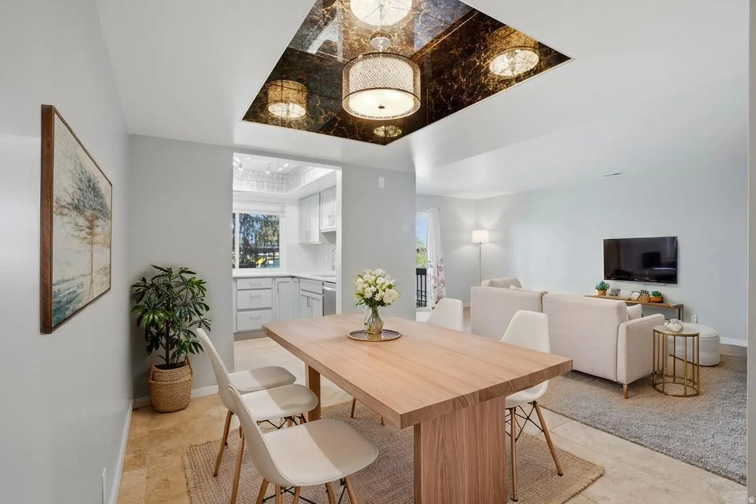 Dining space with a raised ceiling and baseboards