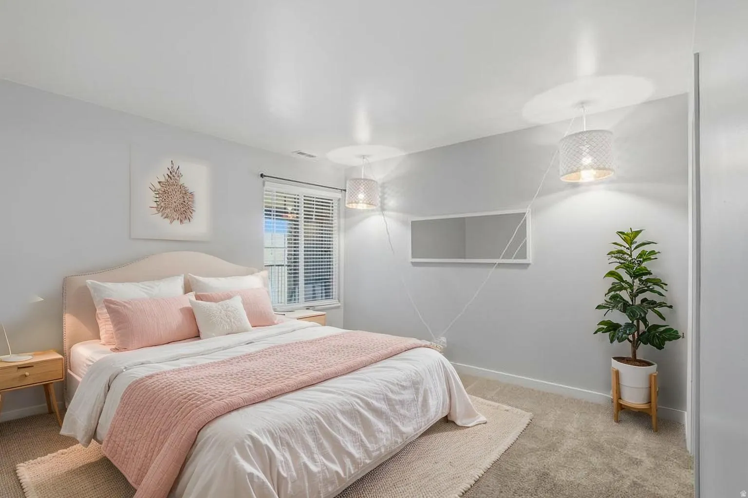 Bedroom with light colored carpet and baseboards