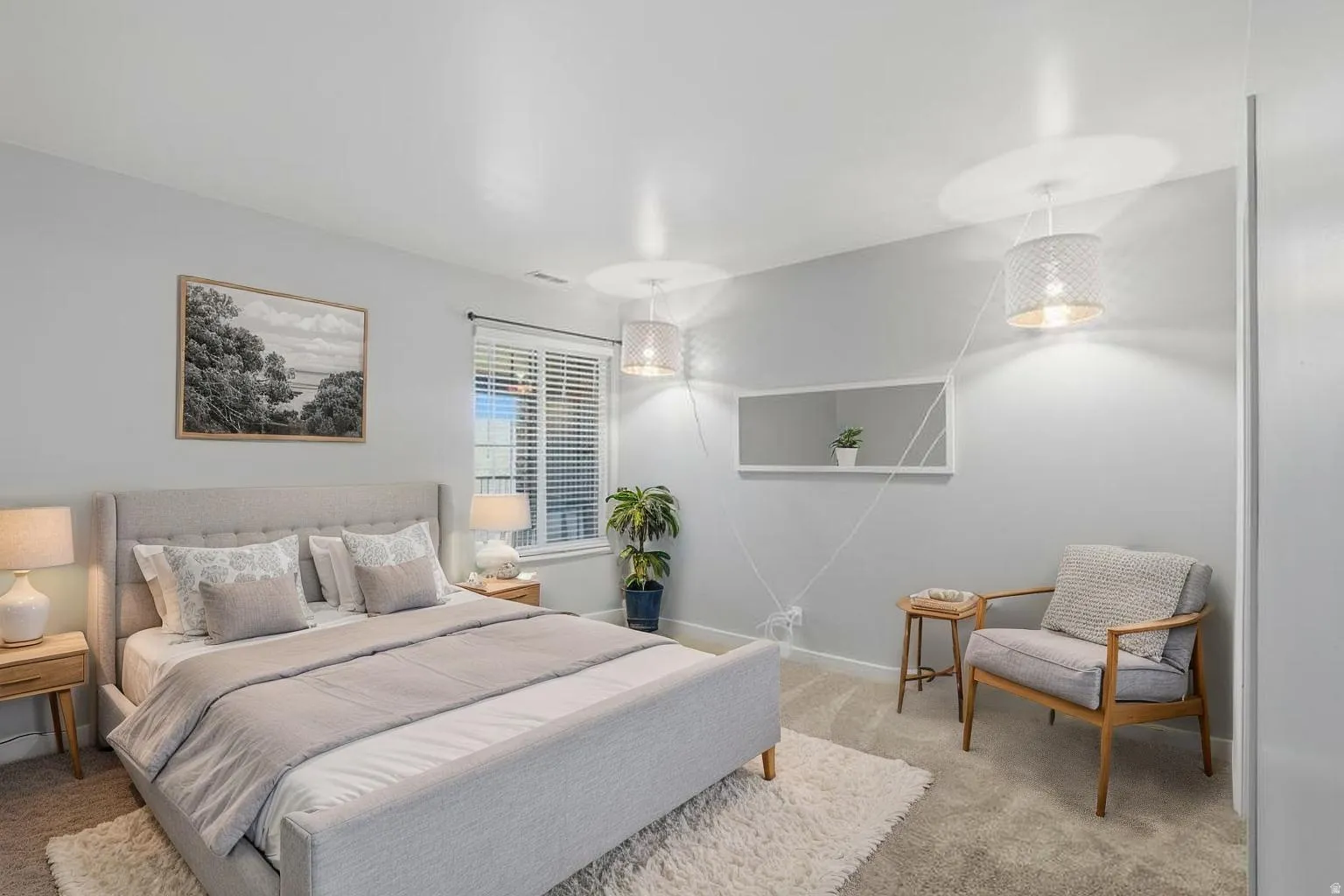 Bedroom with light colored carpet and baseboards