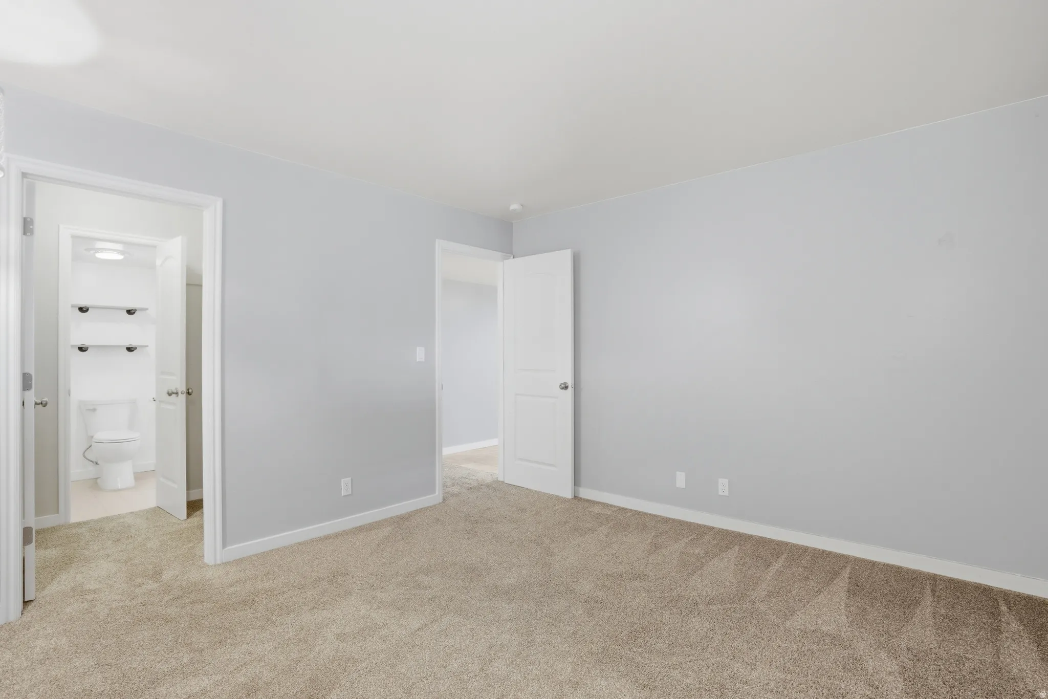 #2 bedroom featuring light carpet and connected bathroom