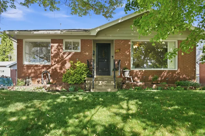 View of front of property with a front lawn and brick siding