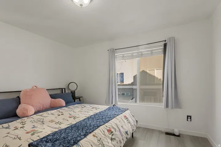 Bedroom featuring baseboards and light wood-type flooring