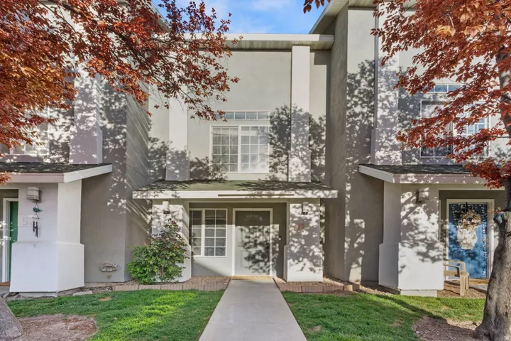 View of front of property with stucco siding and a front lawn