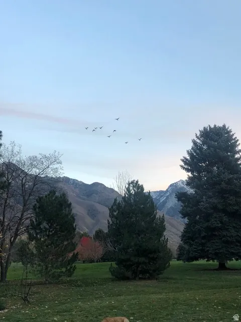 View of mountain backdrop featuring rural landscape