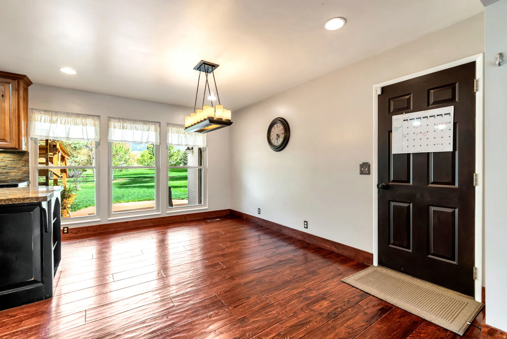 Unfurnished dining area featuring dark wood-type flooring and recessed lighting