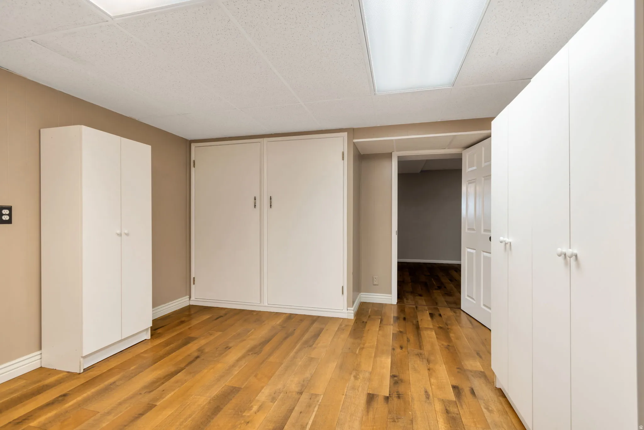 Unfurnished bedroom featuring a closet and light wood-style flooring