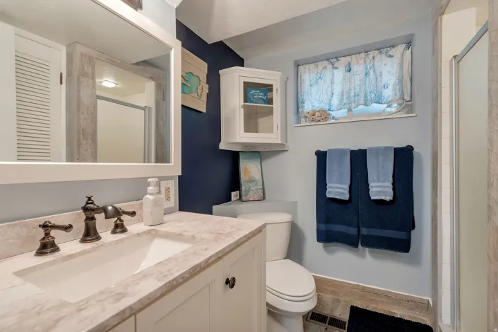 Bathroom featuring vanity and an enclosed shower