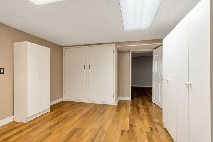 Unfurnished bedroom featuring a closet and light wood-style flooring