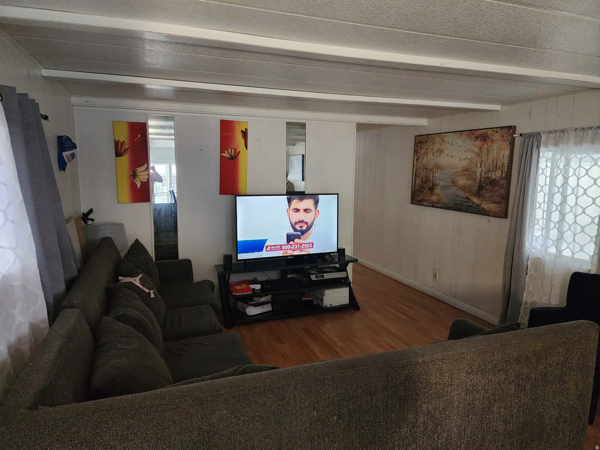 Living area with wood finished floors and beamed ceiling
