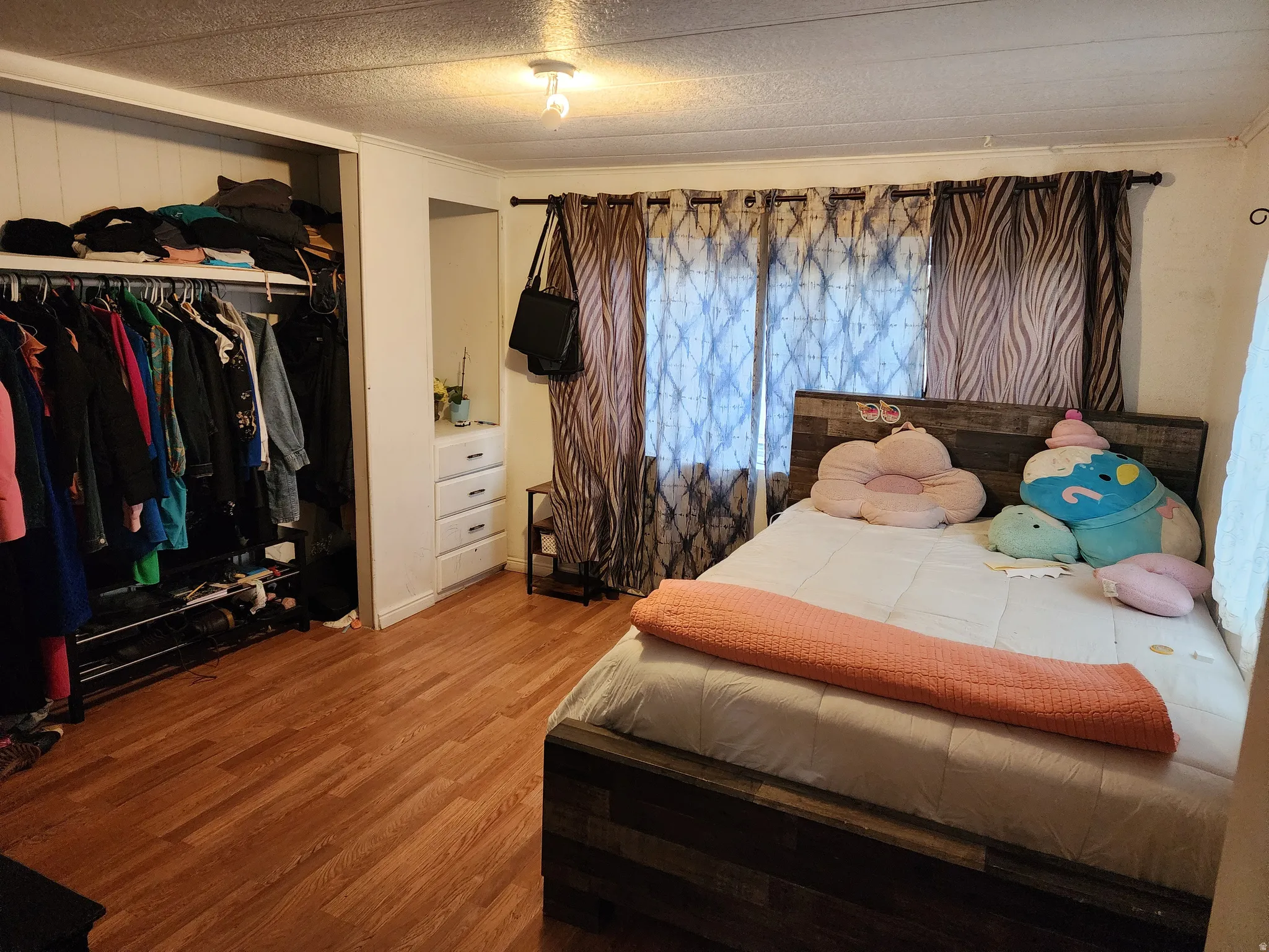 Bedroom featuring a closet and wood finished floors
