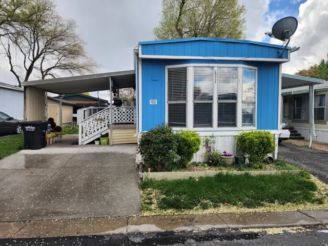 Manufactured / mobile home with an attached carport and driveway