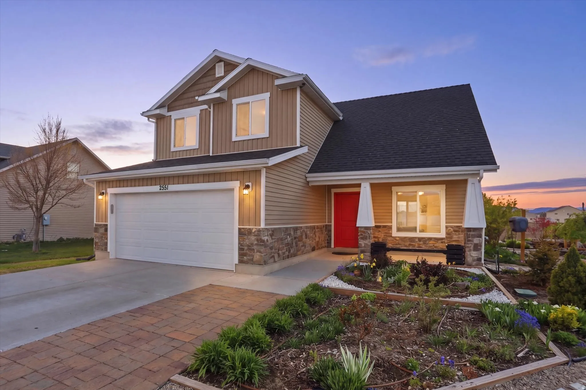 Craftsman-style home featuring concrete driveway, an attached garage, a porch, board and batten siding, and roof with shingles