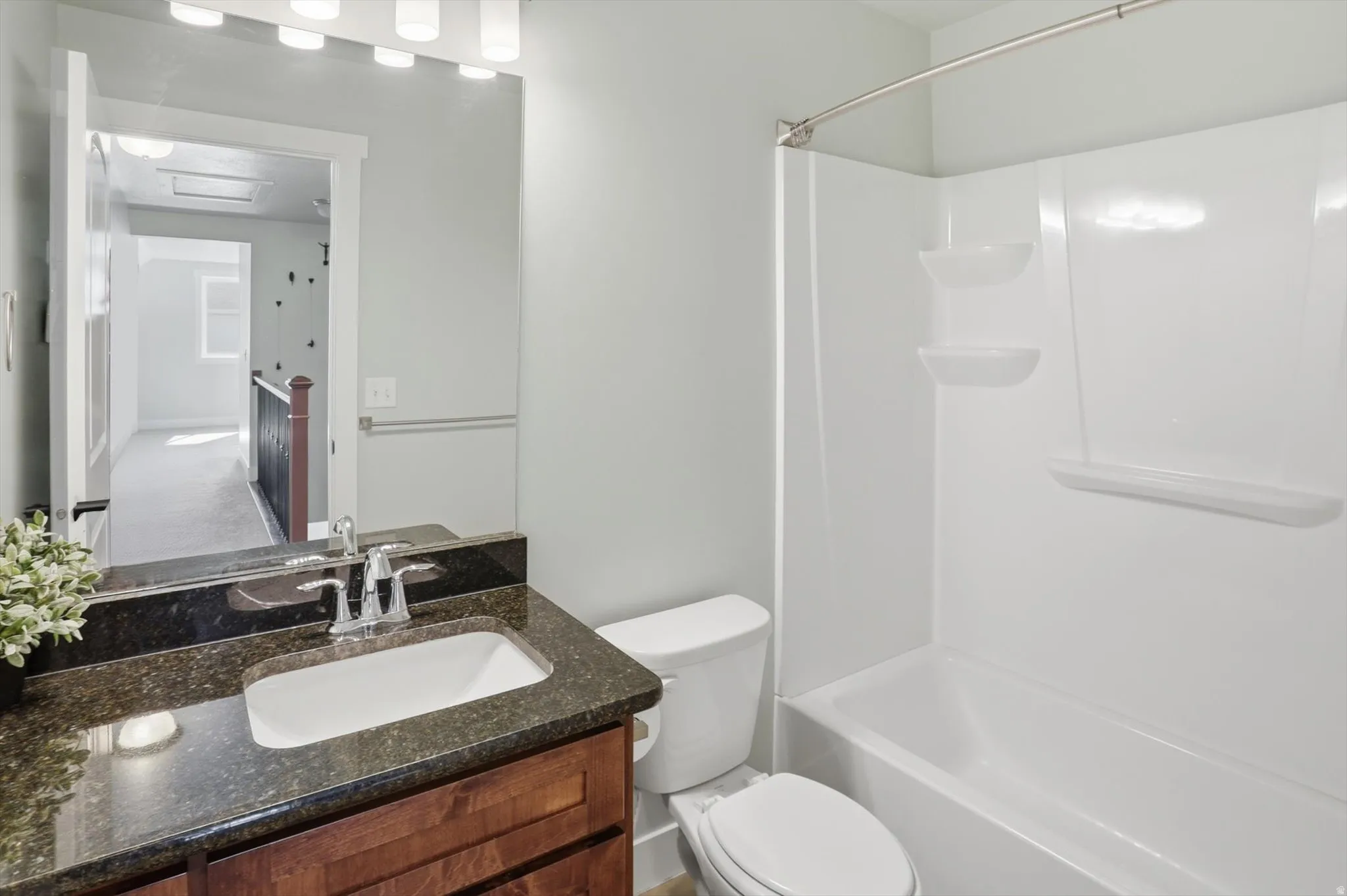 Bathroom featuring vanity and shower / washtub combination