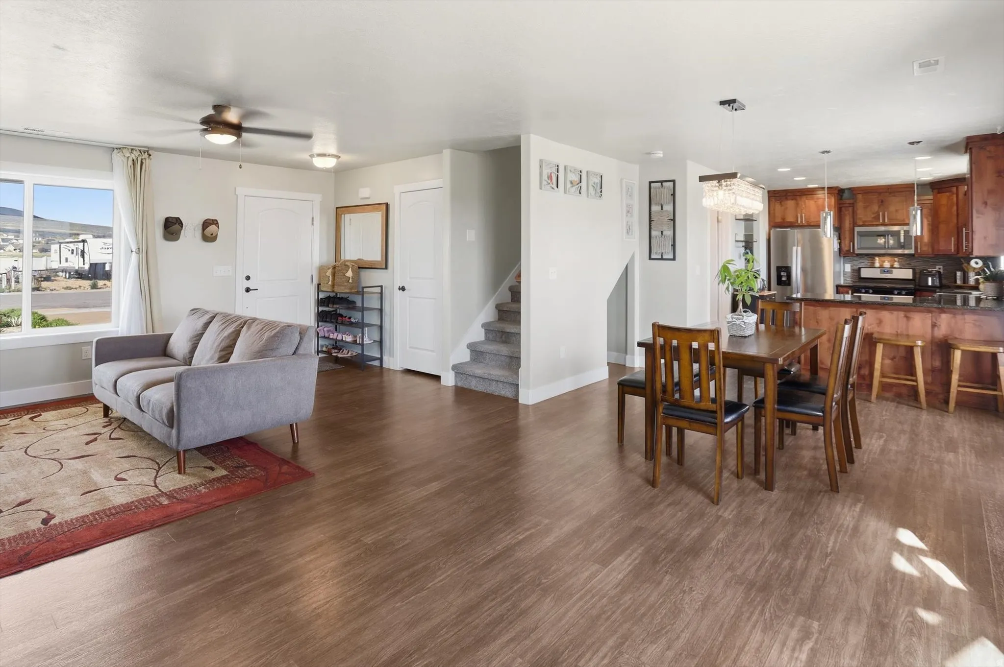 Dining space featuring dark wood-style flooring and a ceiling fan
