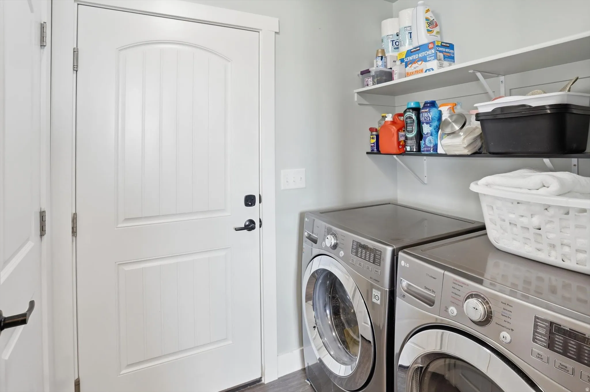 Laundry area with separate washer and dryer and dark wood-style floors