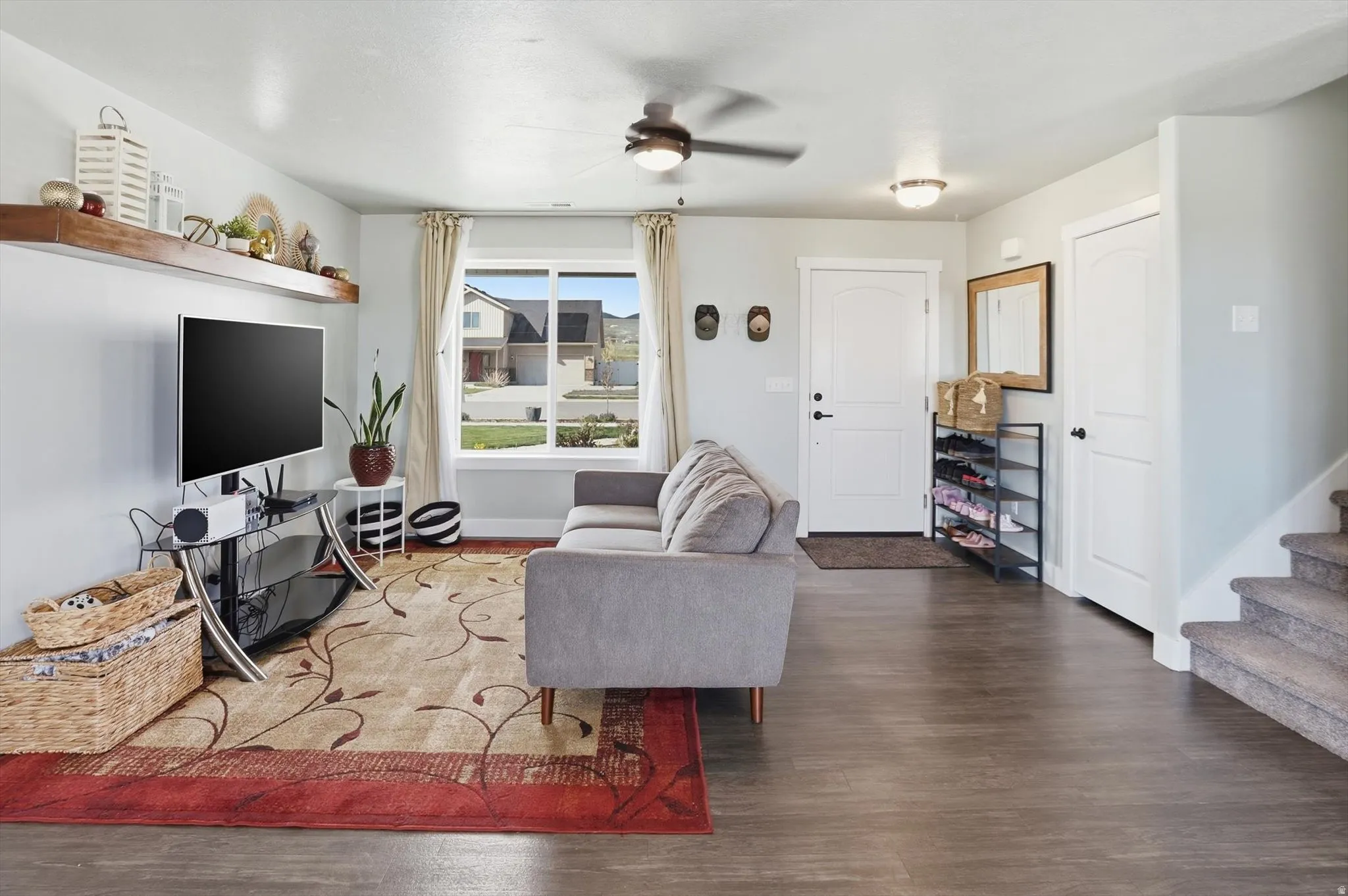 Living area featuring a ceiling fan and wood finished floors