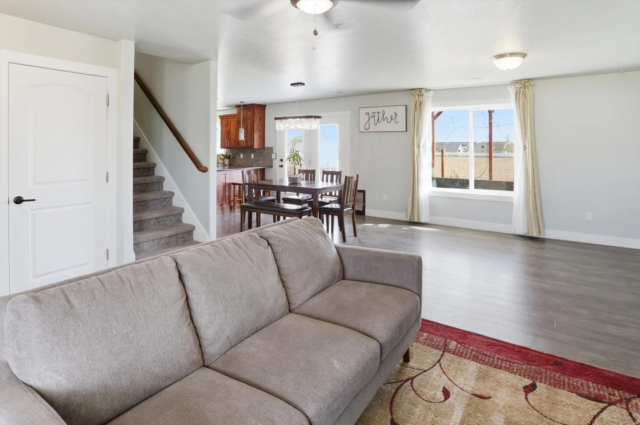 Living area with wood finished floors and a ceiling fan