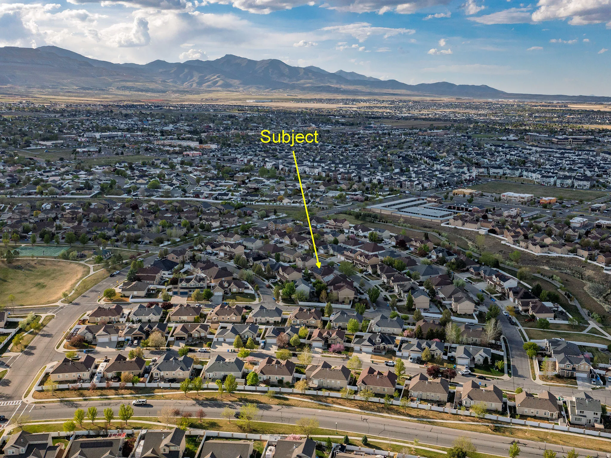 Aerial perspective of suburban area featuring a mountainous background