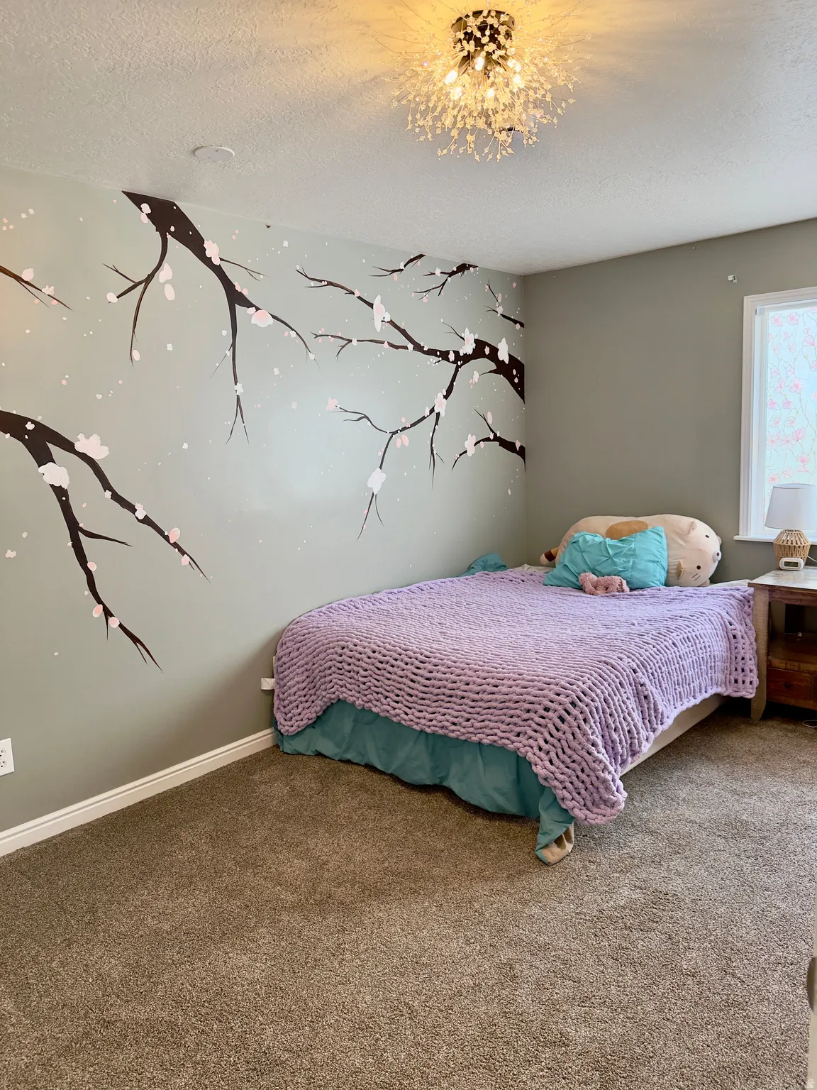 Bedroom with carpet floors, a textured ceiling, and a chandelier