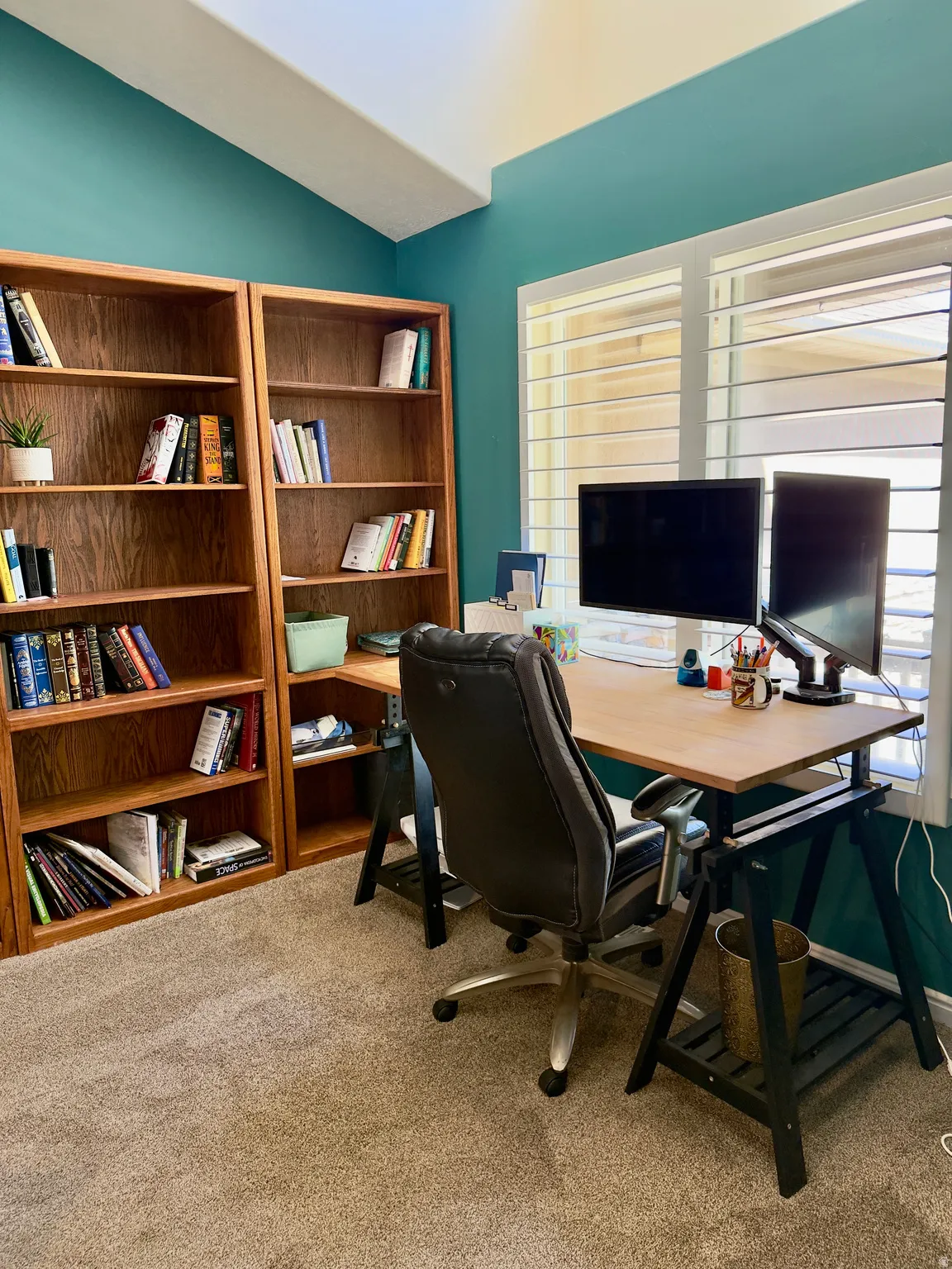 Office featuring light colored carpet and lofted ceiling